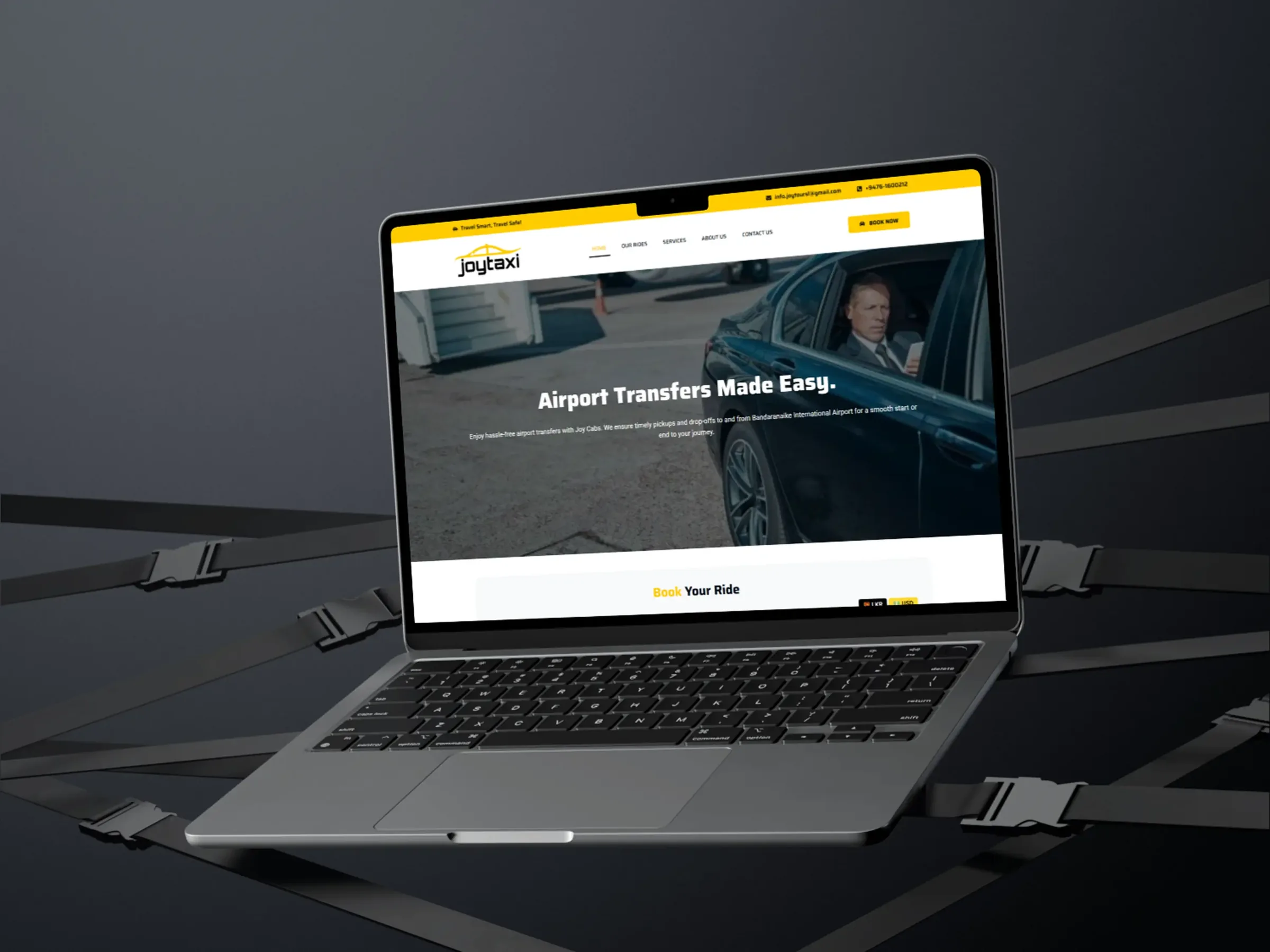 JoyCabs chauffeur booking website displayed on a MacBook Air